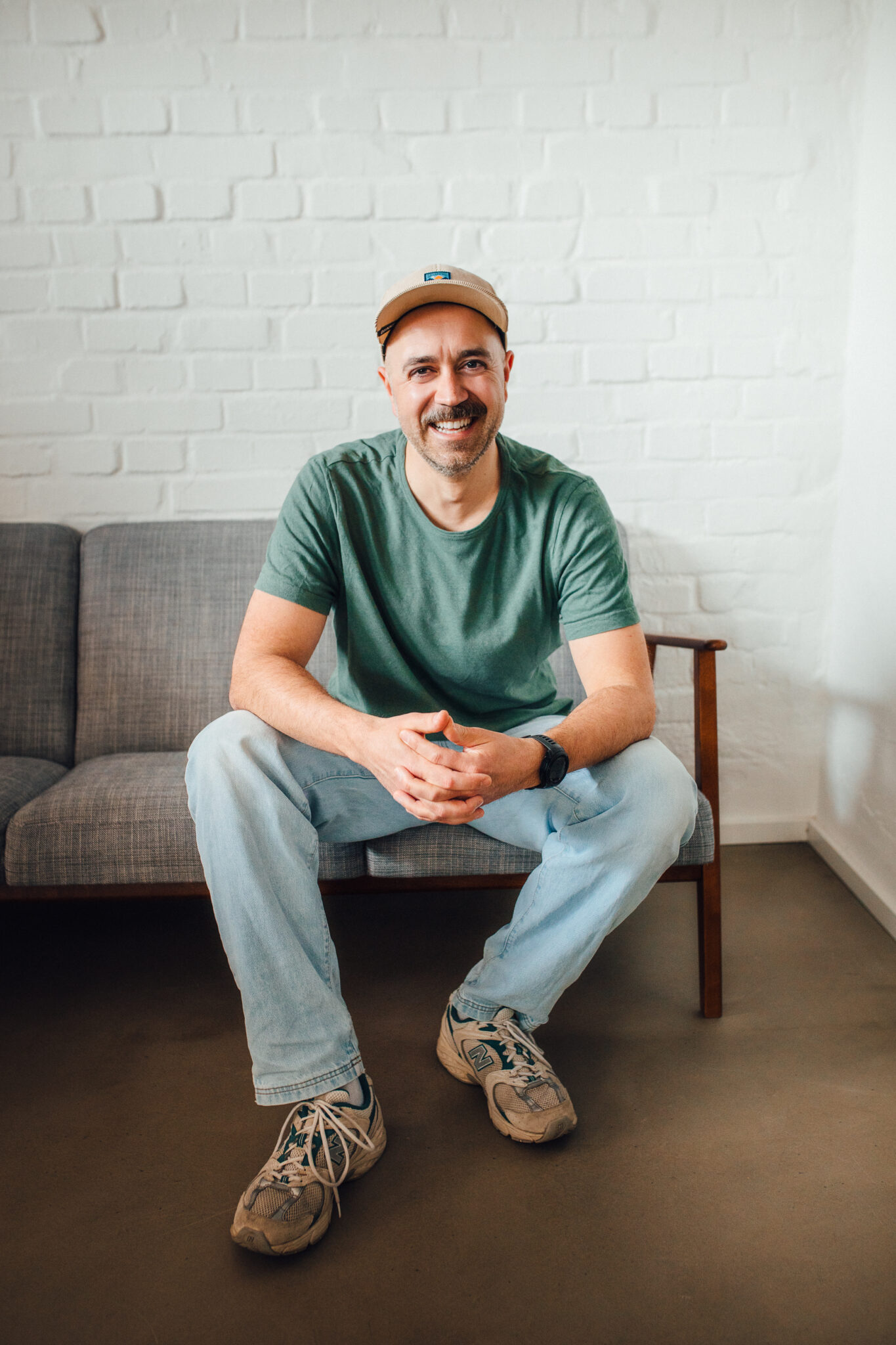 photo of a man sitting on a couch