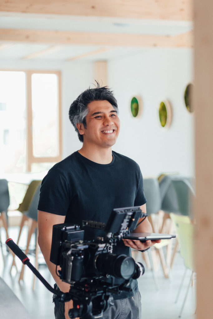 a man standing behind a movie camera