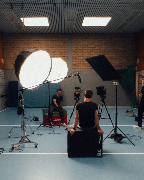 a group of people in a room with lighting equipment
