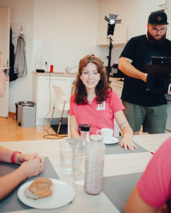 a camera man filming the women chatting